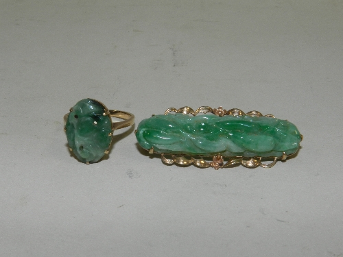 A 9ct. gold and carved jade bar brooch; a similar ring (unmarked)
