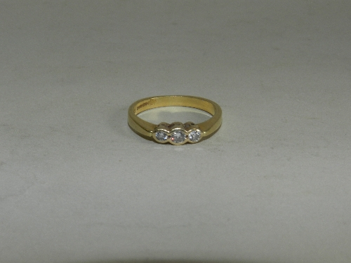 A 9ct. gold three stone diamond ring