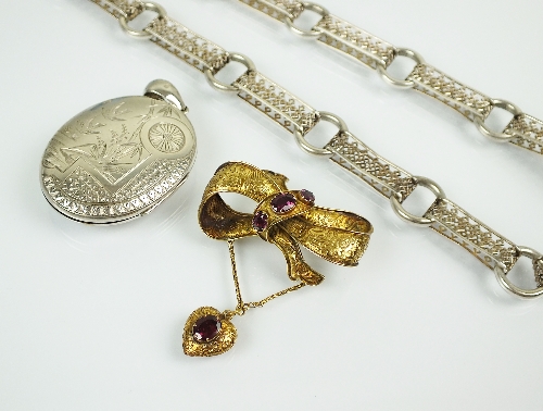 A Victorian yellow metal and almandine garnet set brooch, designed as a stylised yellow metal bow