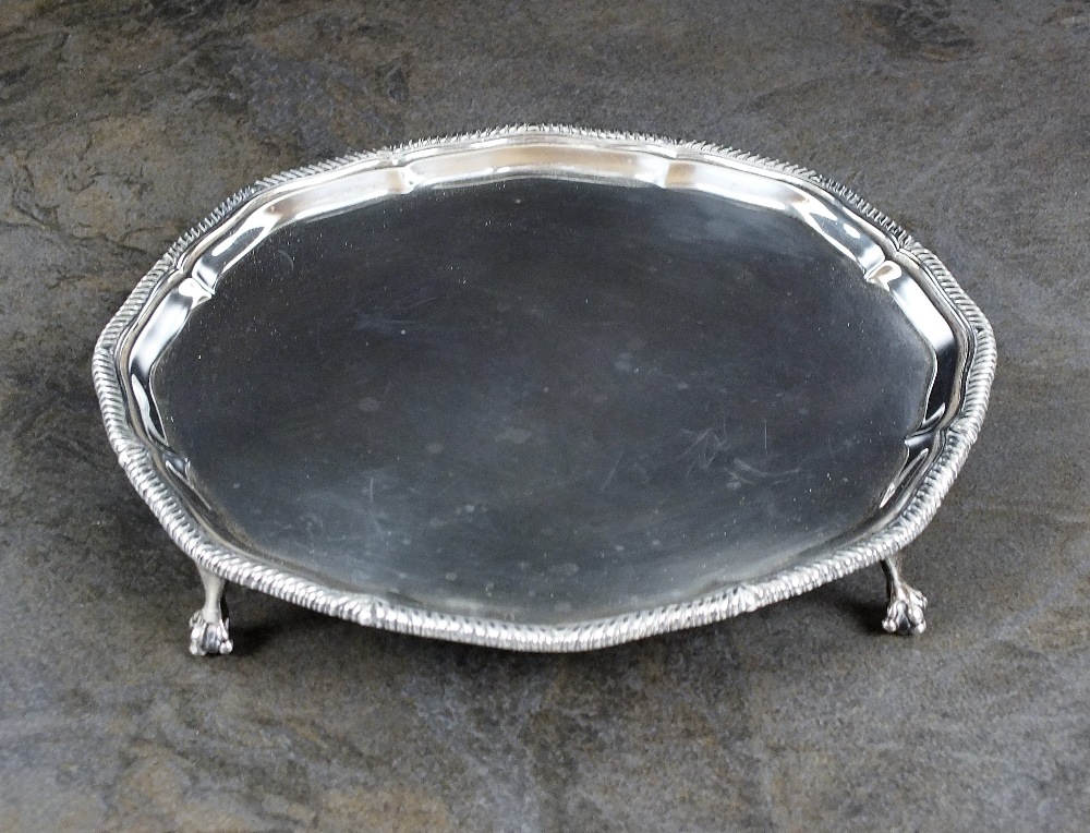 A silver waiter, Goldsmiths & Silversmiths Co Ltd, London 1930, of shaped circular form with