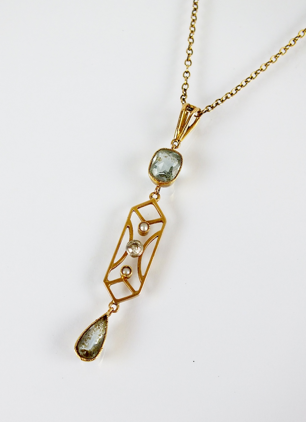 An early 20th century aquamarine, diamond and seed pearl pendant, designed as a central old cut