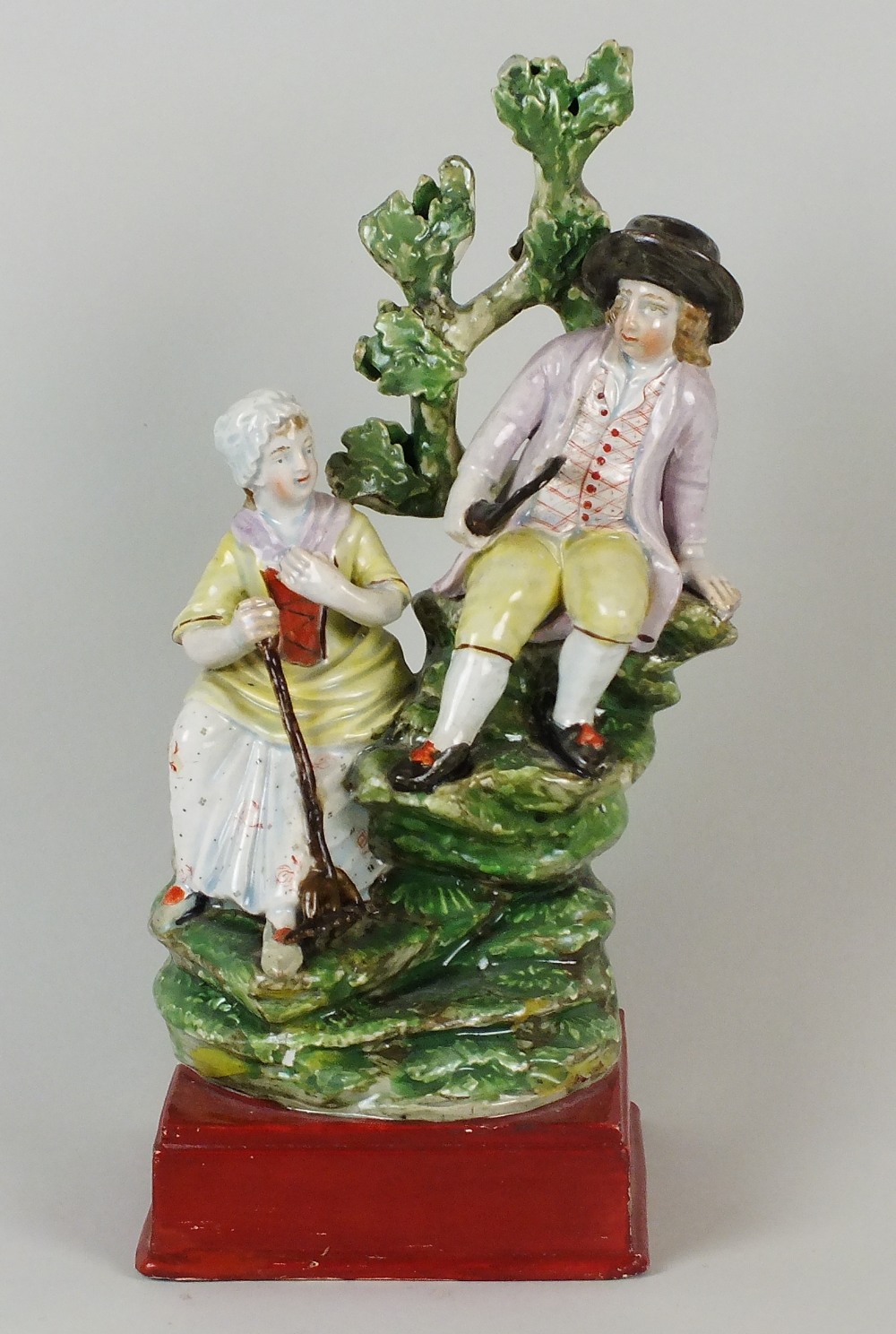 An early Staffordshire pearlware figural group, circa 1780-1800, modelled as male and female