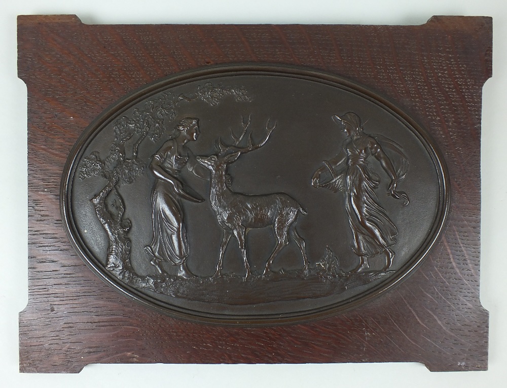 A bronze oval plaque, in the Coalbrookdale style, cast in relief with a scene depicting  two maidens