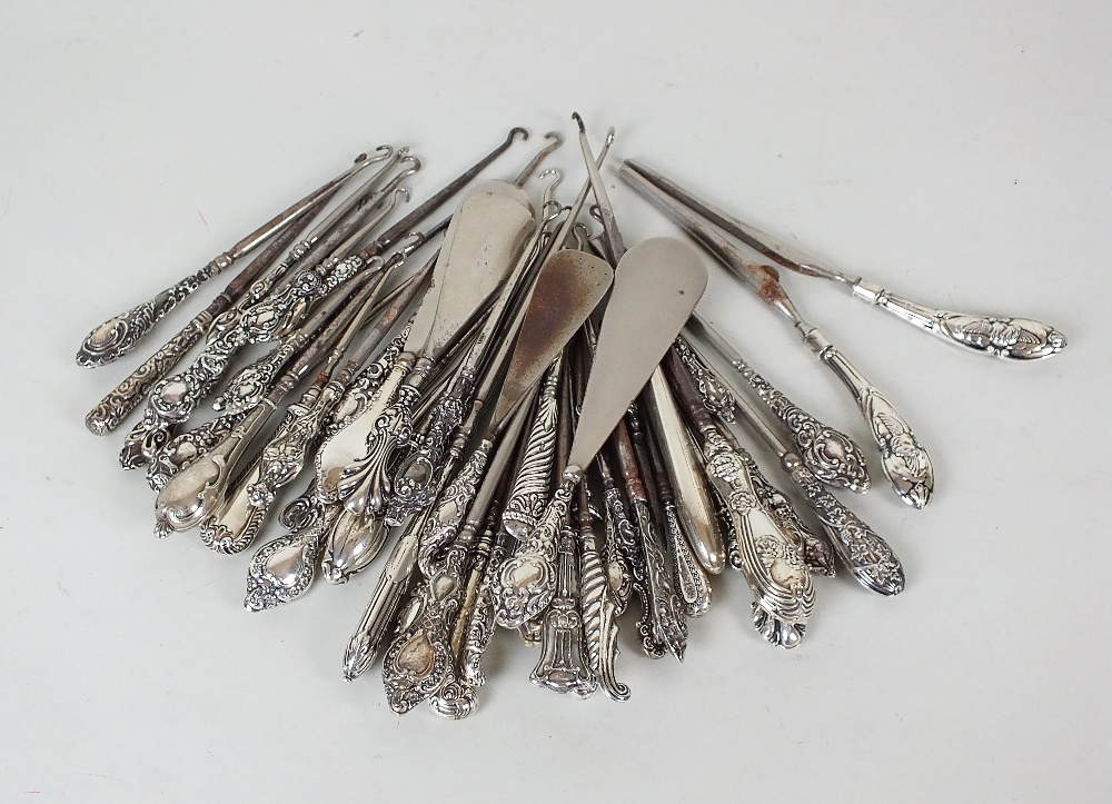 A collection of forty-two silver handled button hooks, of various sizes, together with four silver