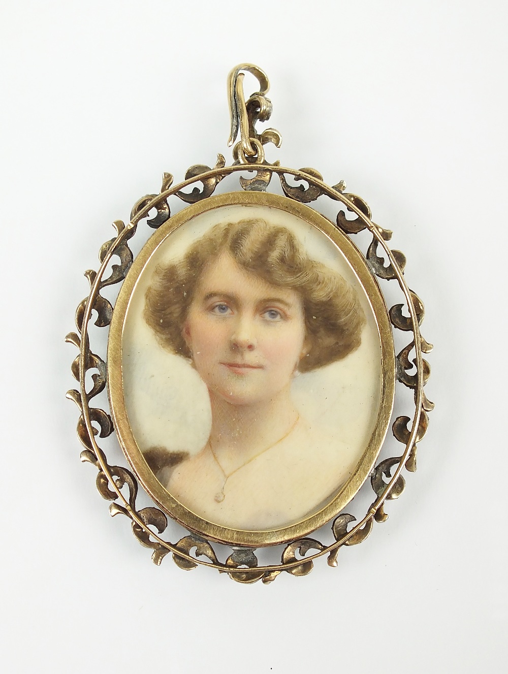 A late 19th/early 20th century miniature portrait pendant, the oval glazed pendant with two