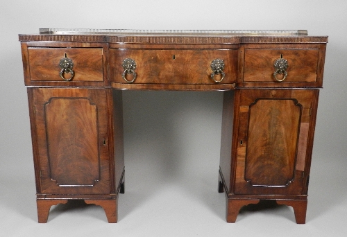 A William IV mahogany breakfront sideboard, the crossbanded top with gilt metal pierced back gallery