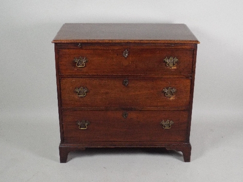 A George III mahogany chest of drawers, the rectangular top with moulded edge over a brushing