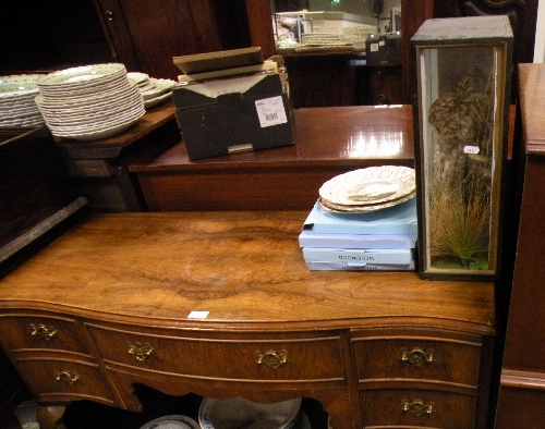 A walnut serpentine sideboard together with a bowfront chest on chest; a taxidermy owl and a