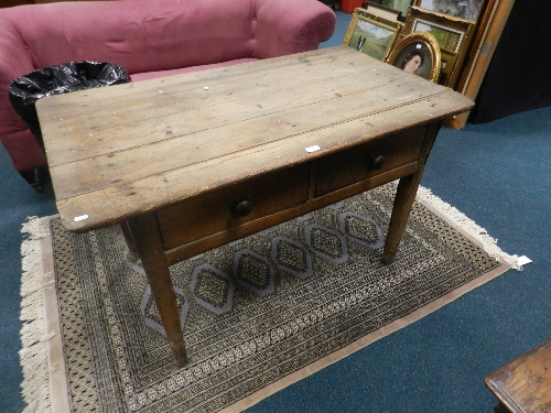 A 19th century pine kitchen table with two drawers on tapering square legs