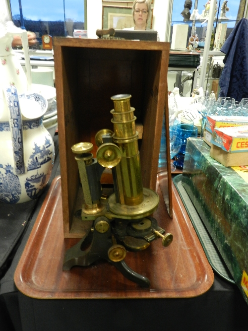 A late 19th century lacquered brass monocular microscope in original mahogany case (unmarked)