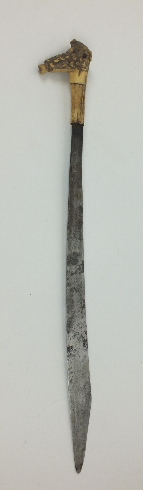 A Malay Dayak Mandau Headhunters sword, with bone handle, blade with partial engraved decoration,