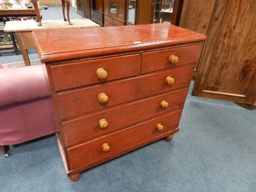 A Victorian stained pine chest of two short and three long drawers on turned legs