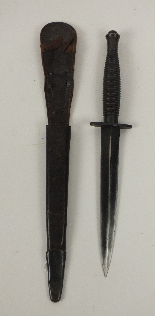 A Second World War British Commando fighting knife, blade length 18.5cm, complete with leather