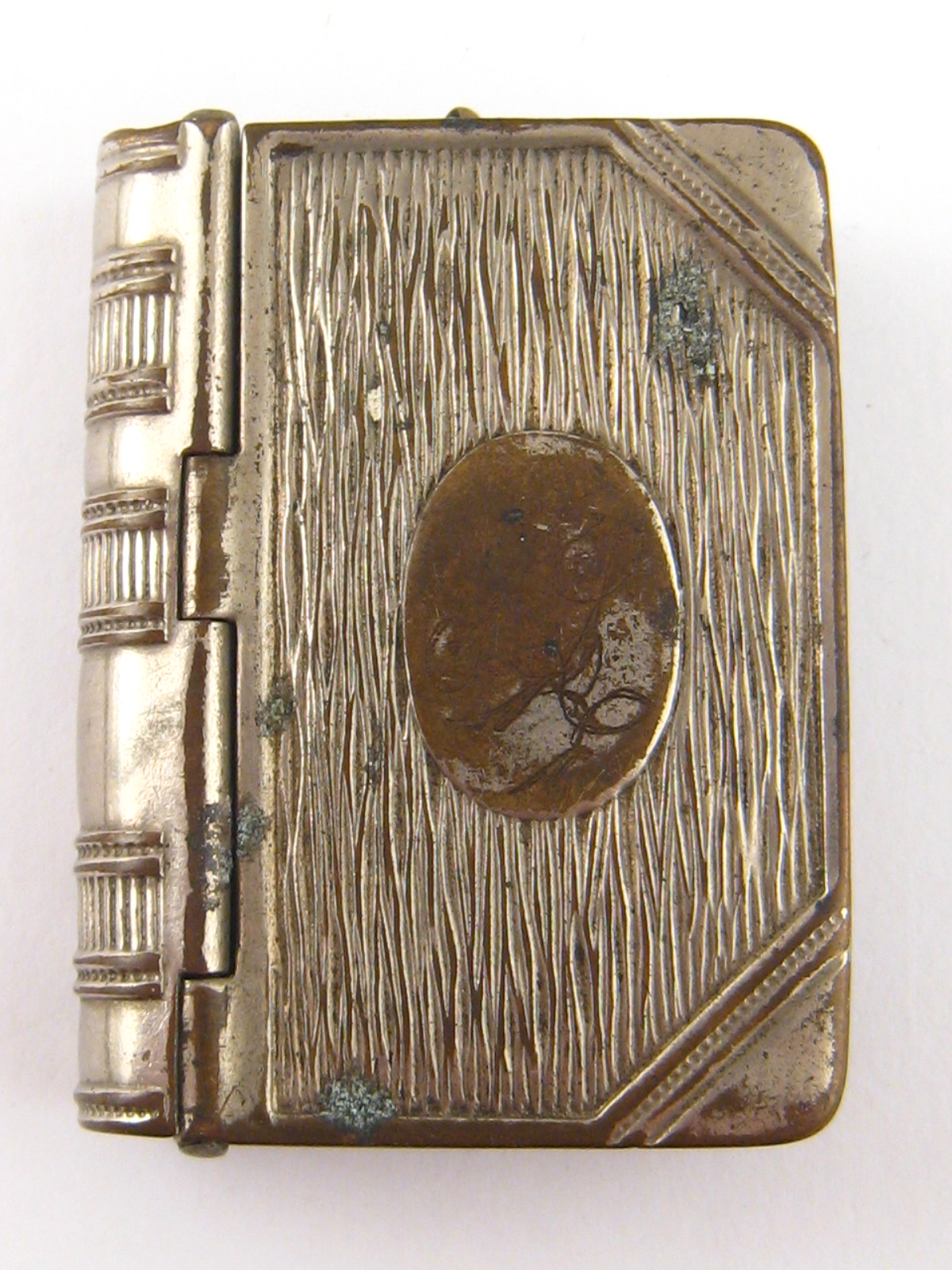 A silver plated vesta case / stamp box designed as a book, with sprung covers, approx 5x3.5cm.