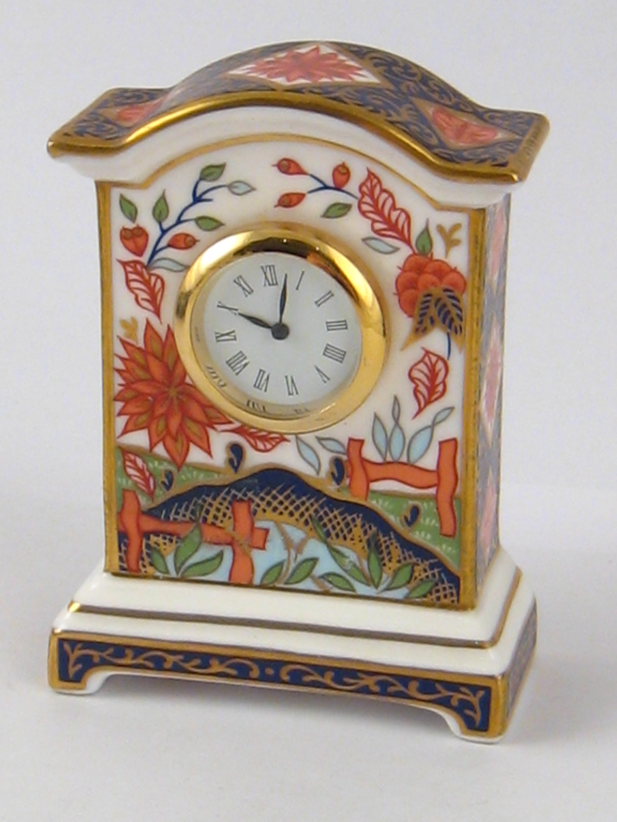 A Royal Crown Derby mantel clock, approx 7.5cm, in original box.