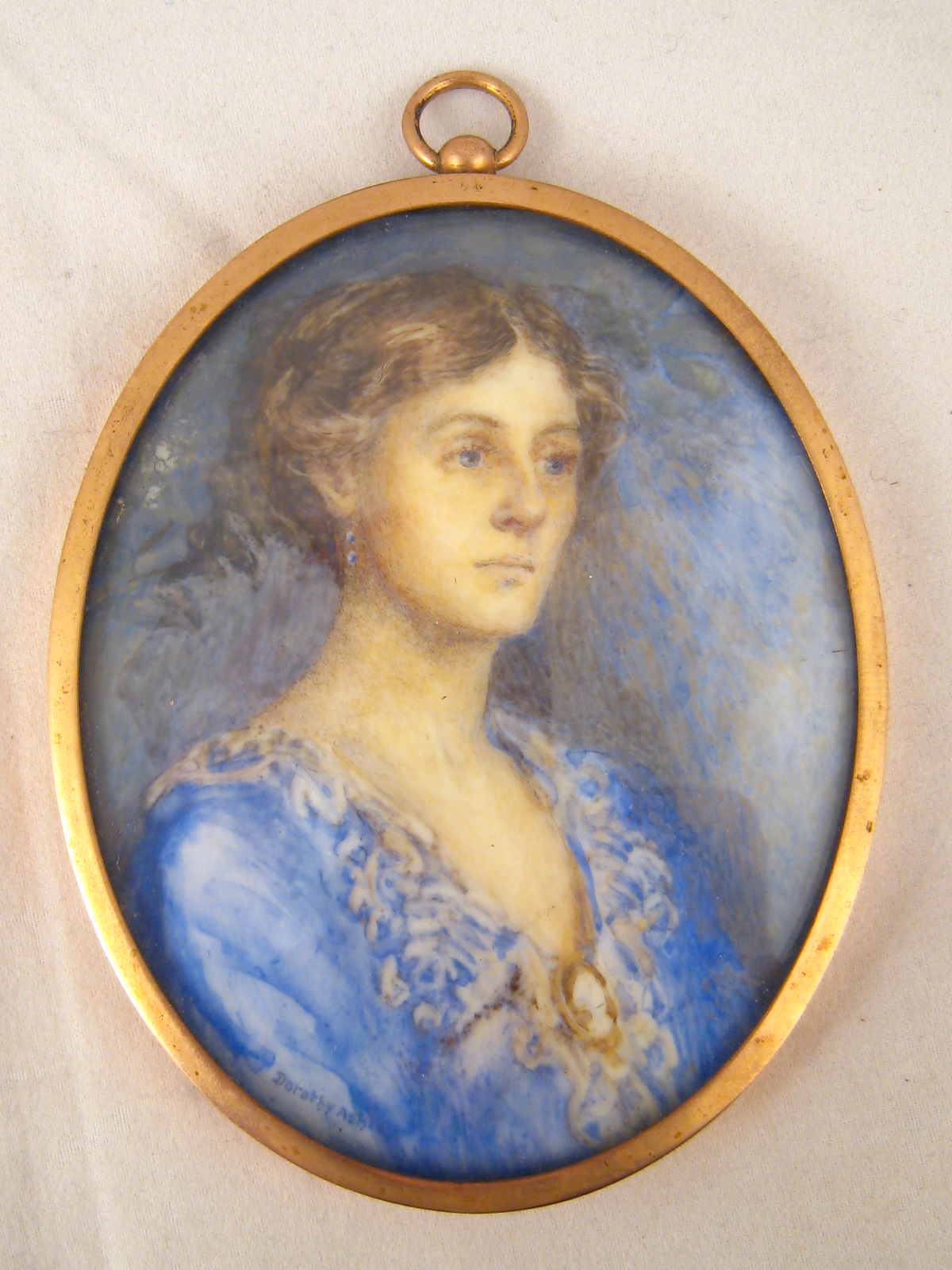 Three portrait miniatures, being a lady in Edwardian dress in a gilt oval frame, signed, 7x9cm, in
