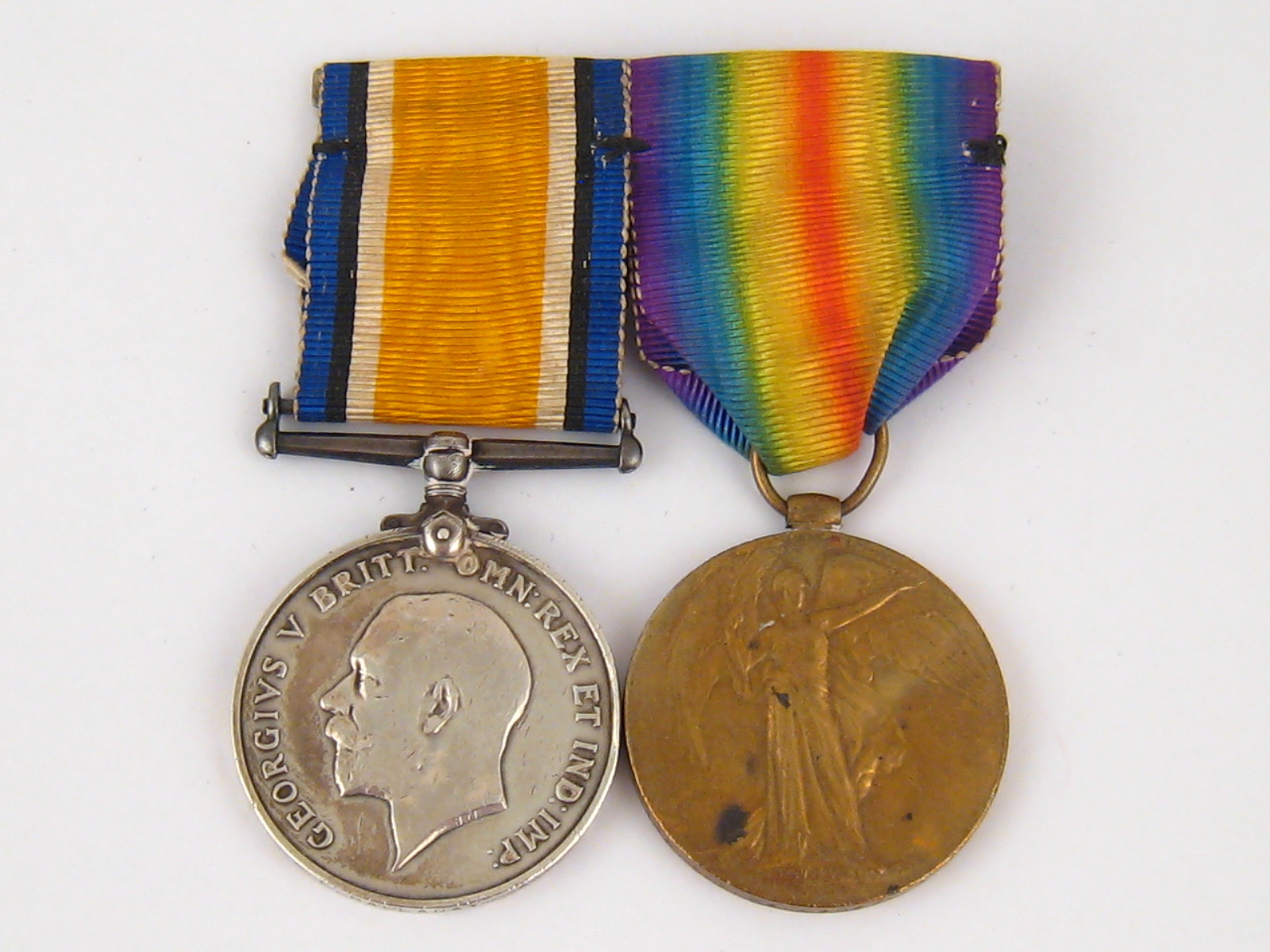 Two WW I Victory medals, complete with ribbons.