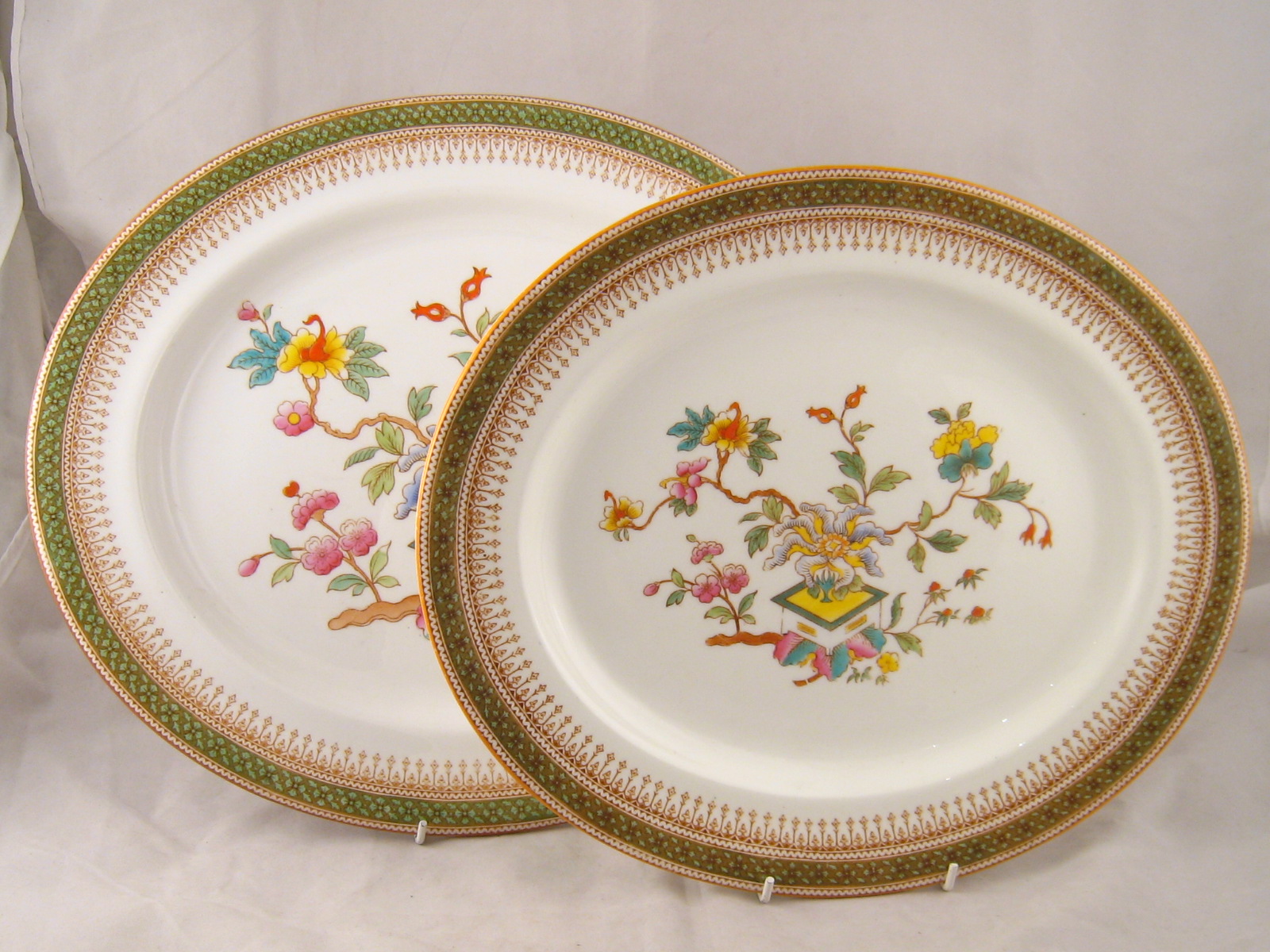 Royal Worcester. A graded pair of ceramic  meat dishes, the centre with a plant set in a square