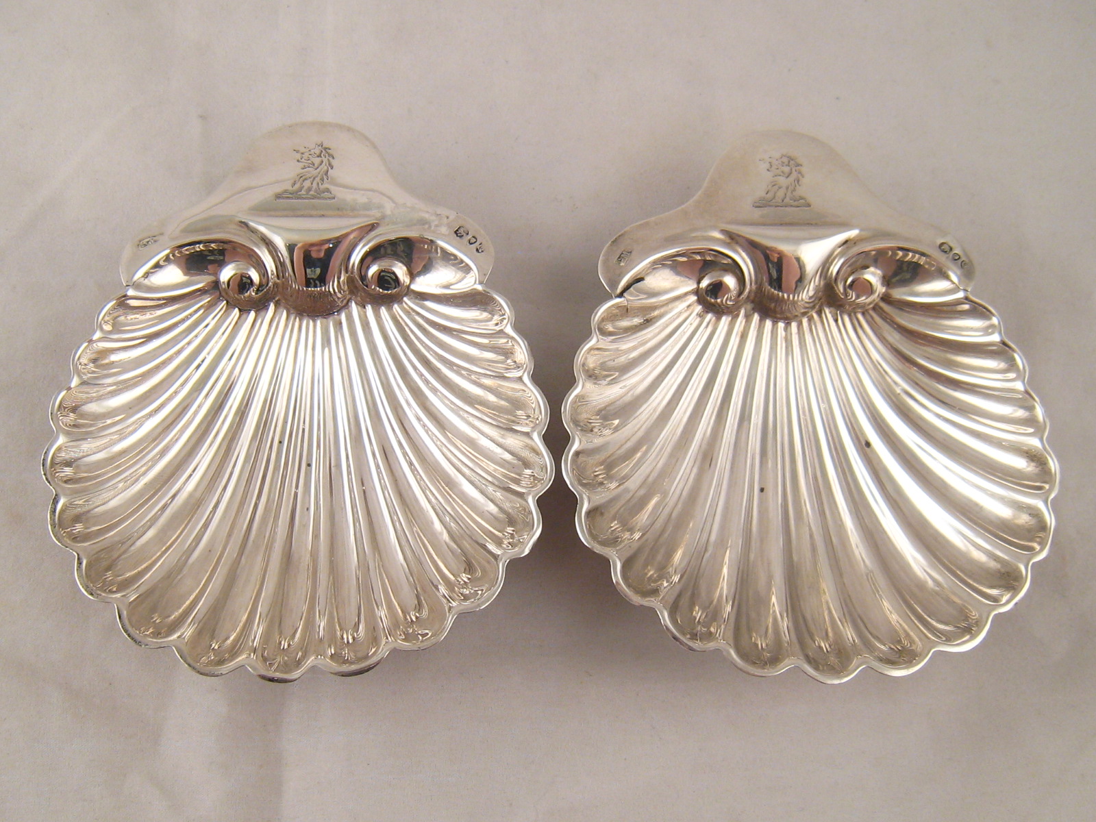 A pair of late Victorian sterling silver shell butter dishes on ball feet, By George Maudslay