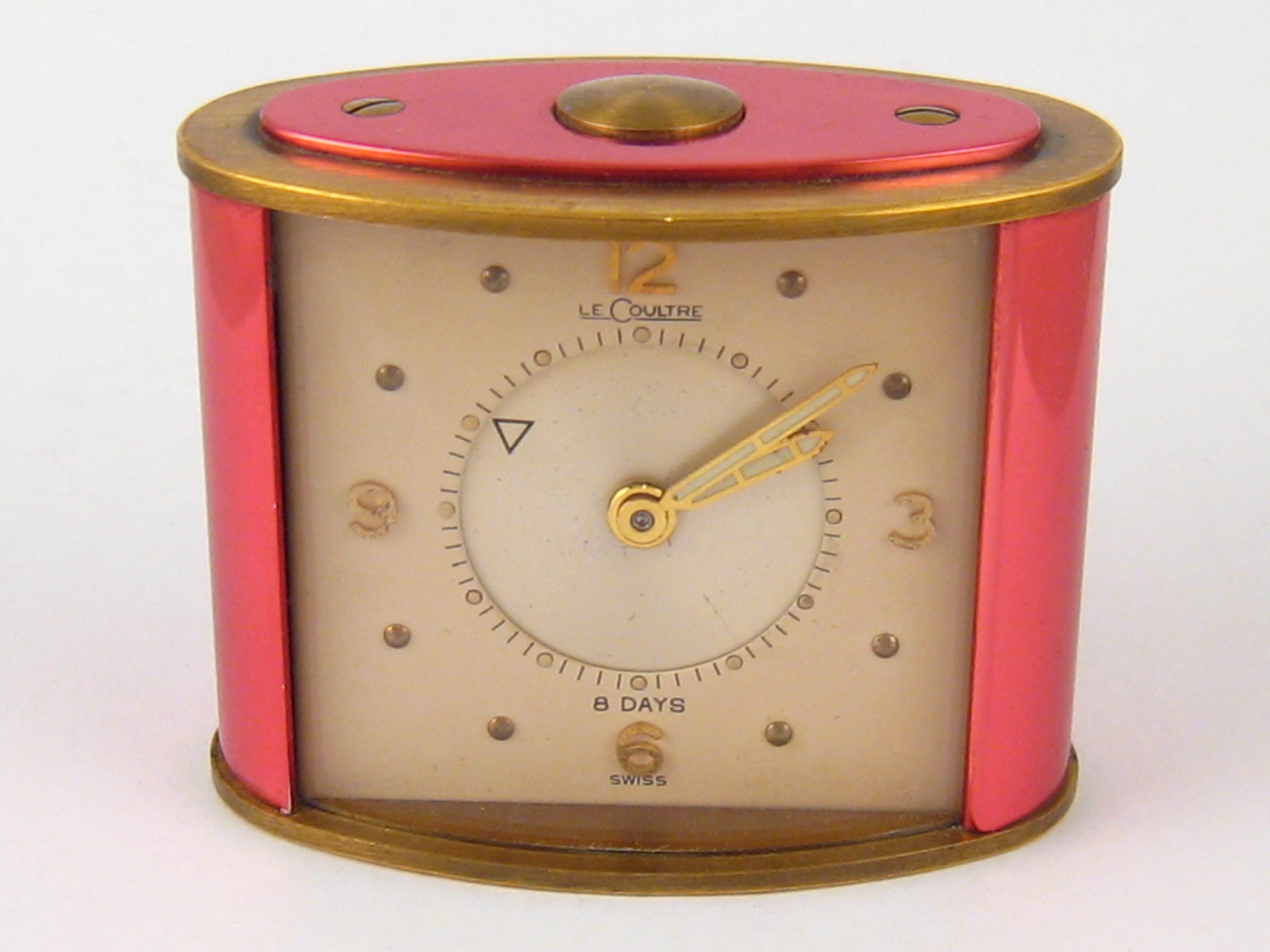 A brass and lacquer Jaeger Le Coultre alarm clock, the dial signed Le Coultre, approx 5 x 6 cm.