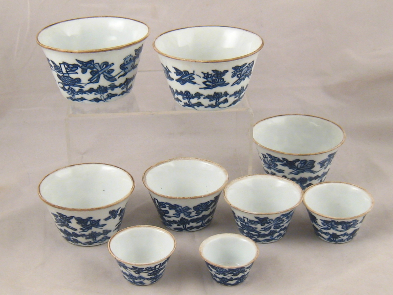 A set of nine Chinese ceramic bucket shaped nesting bowls, largest 10cm, in protective case, as used