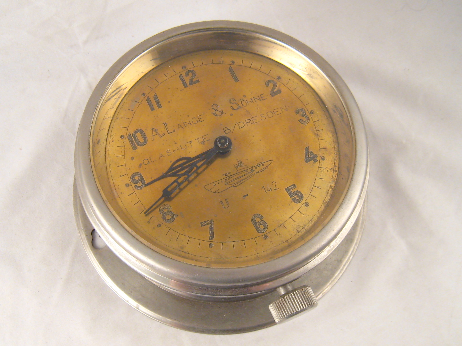 WITHDRAWN. A German WWII U boat bulkhead clock with alloy case and brass dial engraved " A.