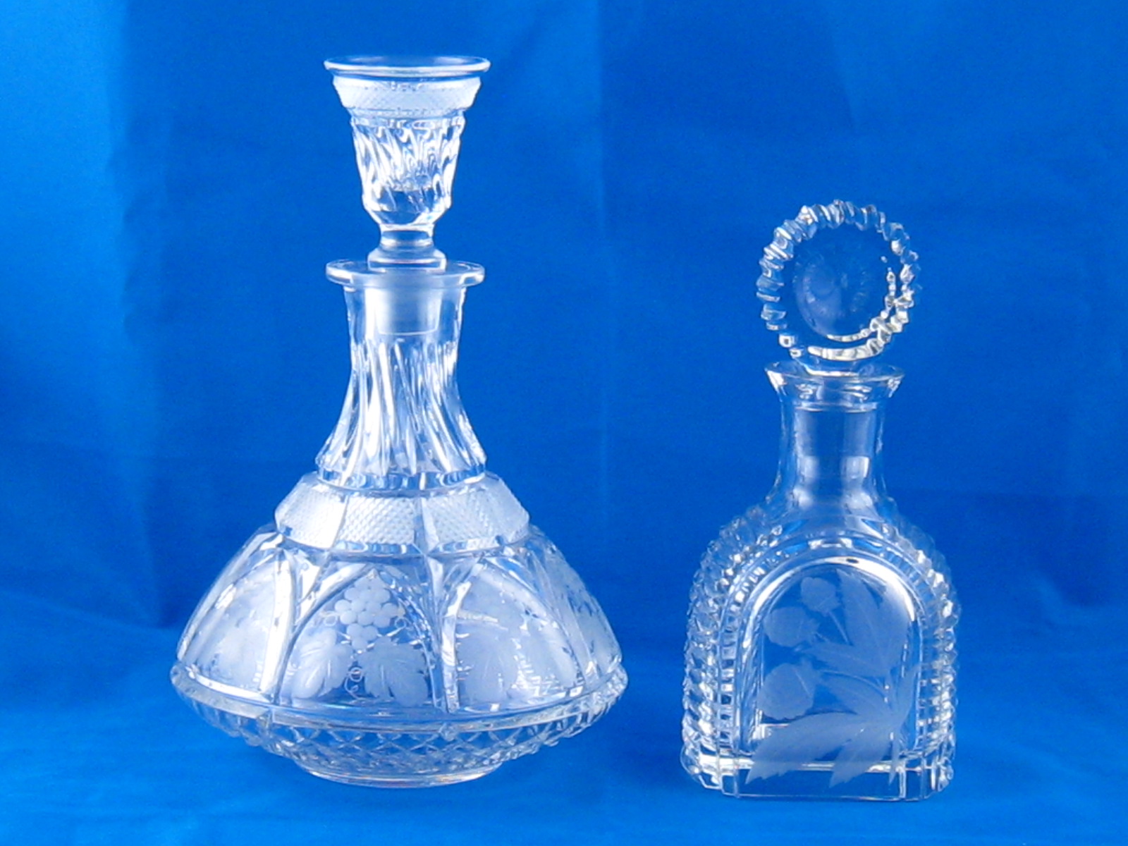 Two Soviet cut glass decanters, one broad based , cut and wheel engraved with fruiting vines, the