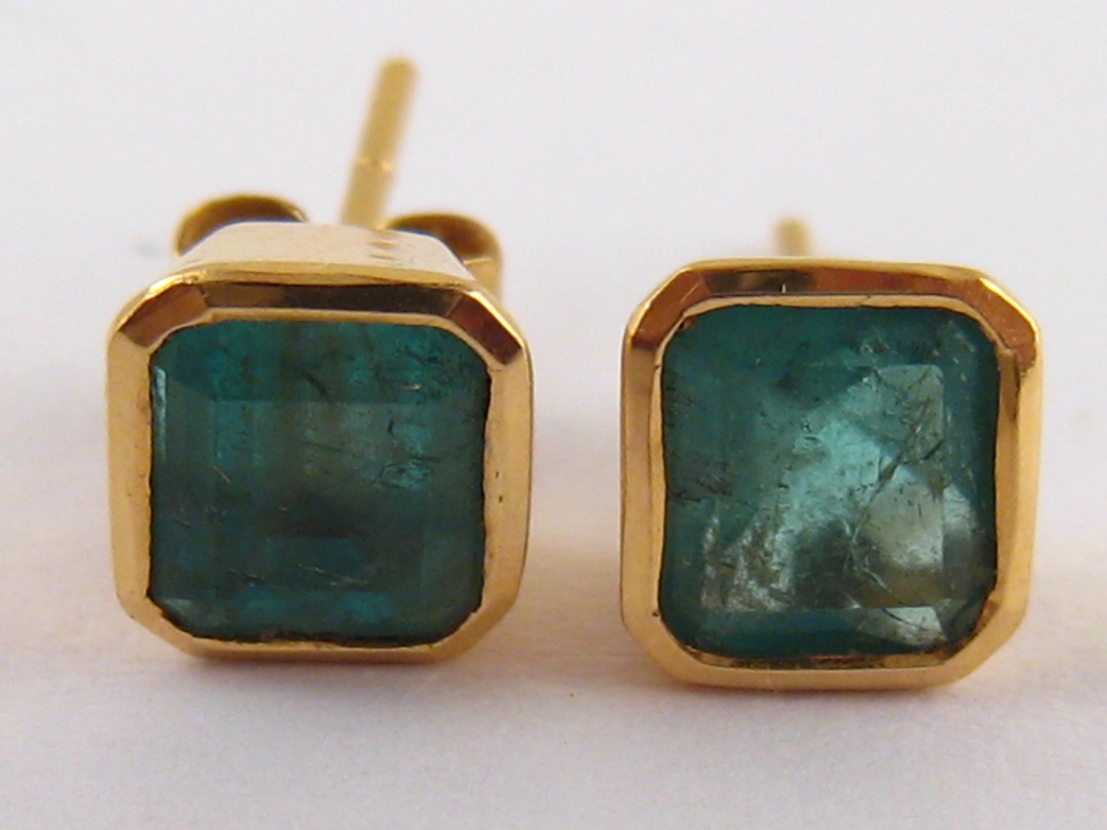 A pair of emerald ear studs, emeralds approx 6x5mm, 1.8 gms.