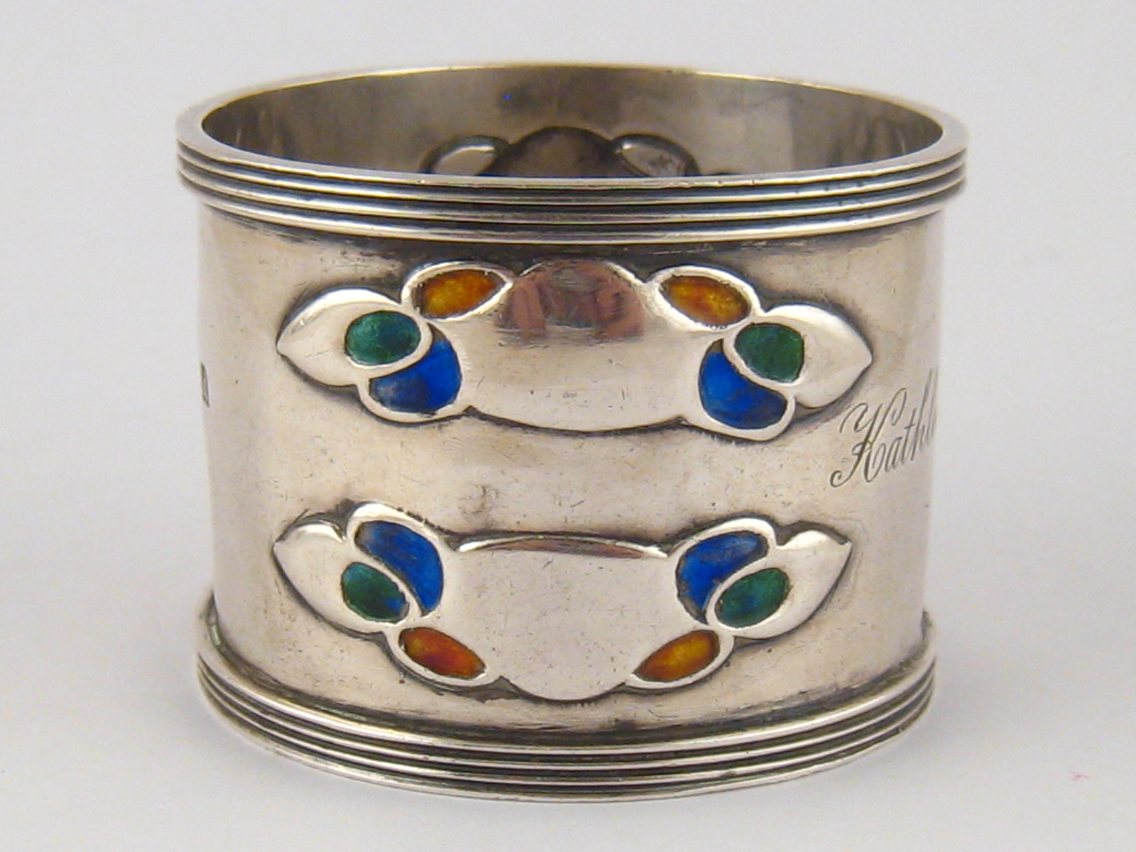 A Liberty &co. Arts and Crafts silver napkin ring with ribbed bands and  two  double shaded enamel