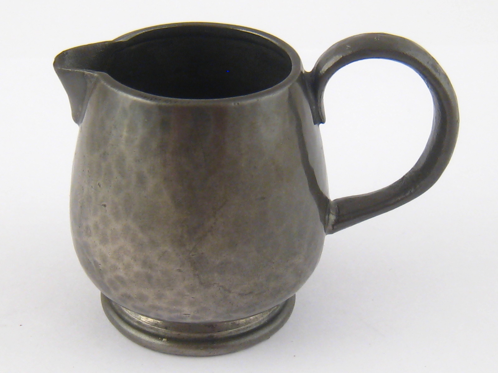 A Liberty's Tudric pewter cream jug, Marks "Tudric", "Liberty & Co."  "O 1373". Ht. 5.5cm.