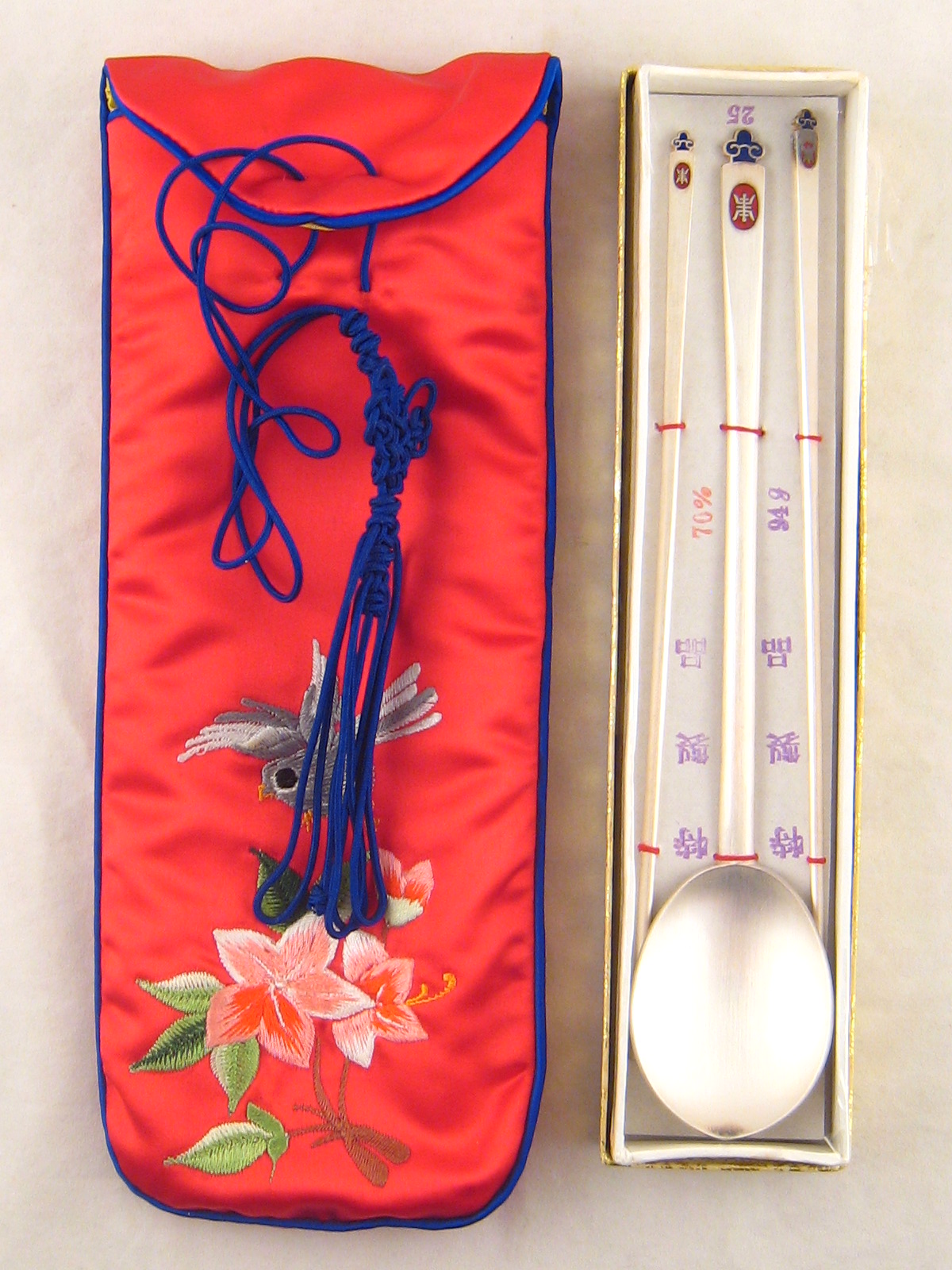 A Chinese white metal (untested) long spoon and chopsticks with brushed finish and enamel finial