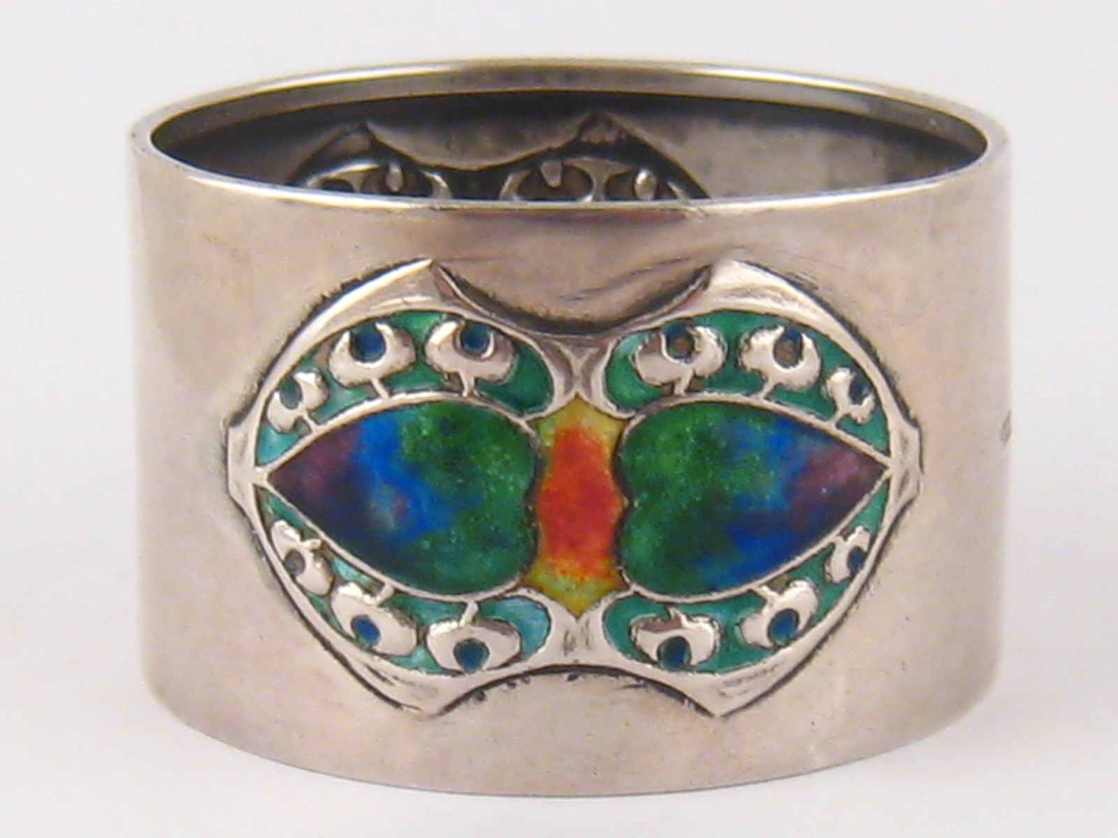 A Liberty &Co. Srts and Crafts silver napkin ring, model 1335,  with two shaded enamel double