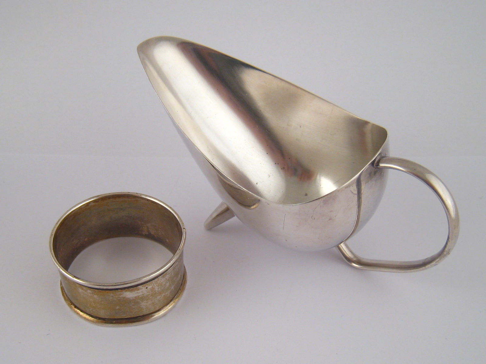 A very stylish silver plated butter sauce or cream boat, c.1950, mark of WMF. l. 12cm, together with