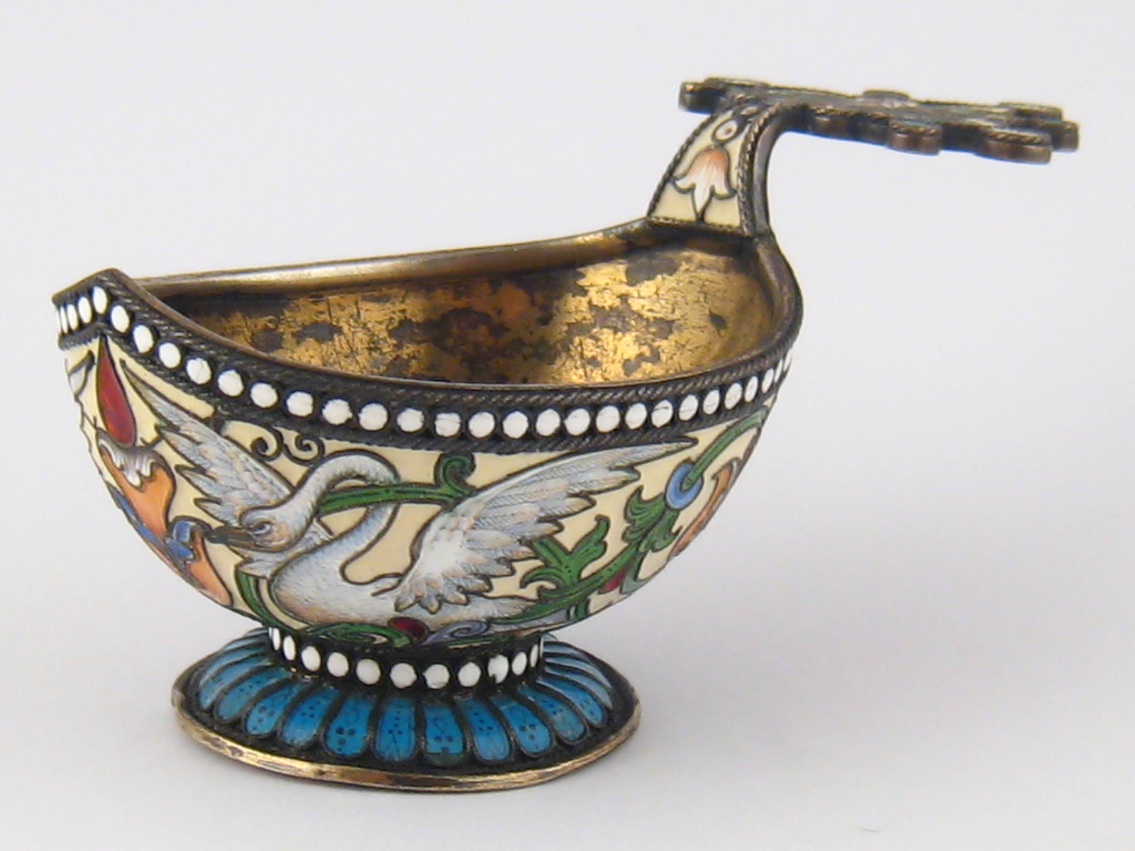 A Russian silver gilt cloisonne enamelled kovsh decorated with swans and foliage, the plumage  and