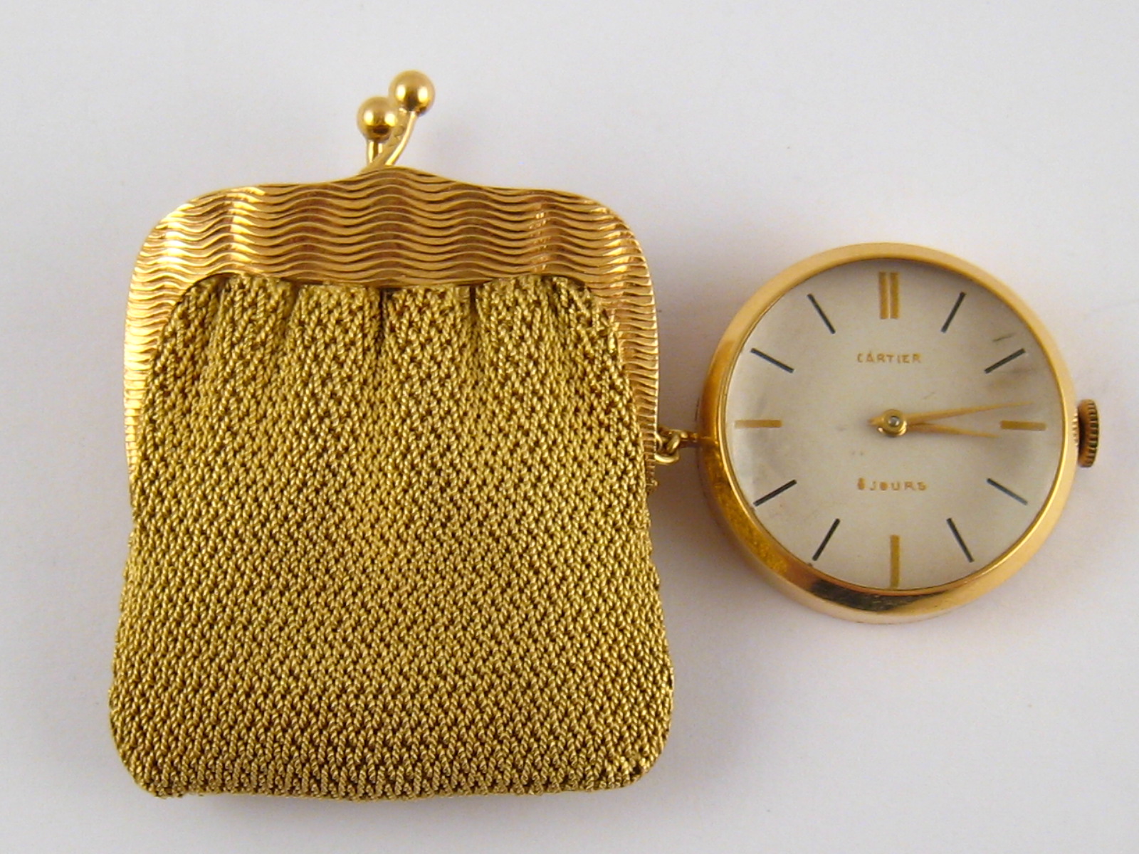 Cartier. A French hallmarked 18 carat gold purse watch, the dial and movement signed Cartier,