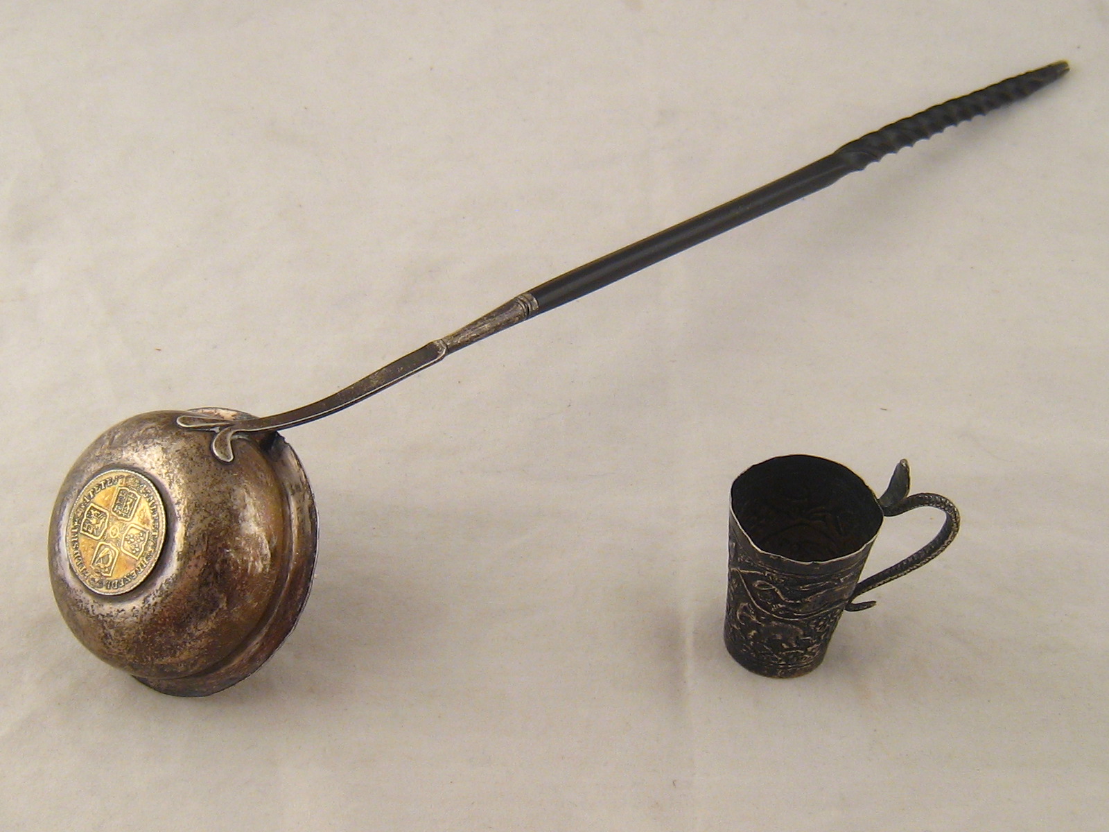A Georgian silver toddy ladle with whalebone handle, c.1780, the bowl formed from a George II