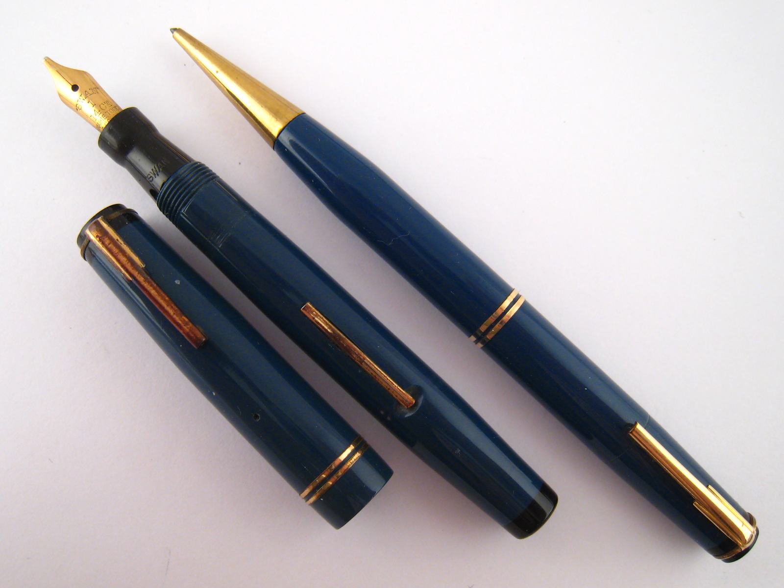 A navy blue Swan Mabie Todd side lever fountain pen, 14ct gold nib, together with a matching “Fyne