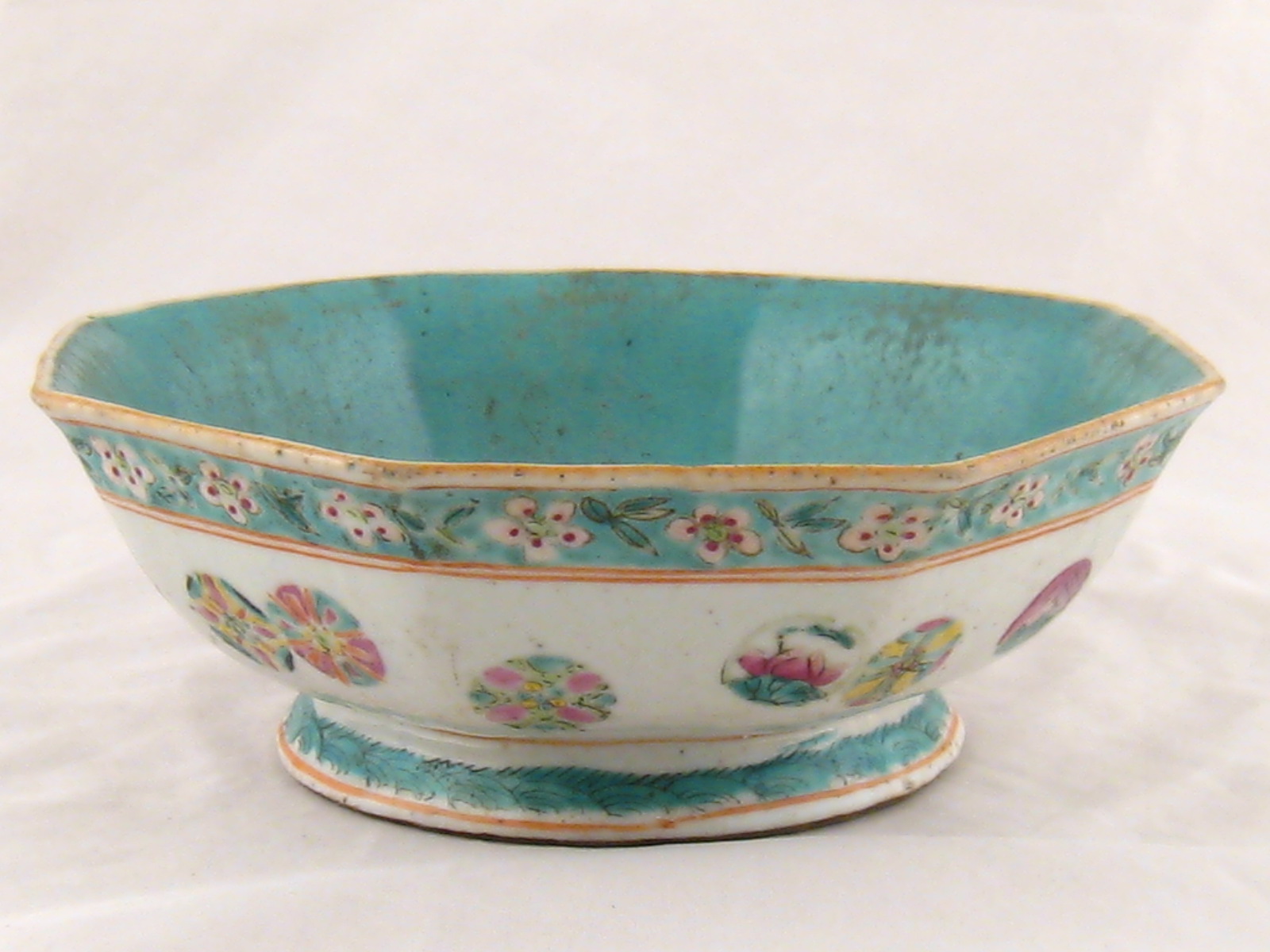 A Chinese 19th. c. ceramic octagonal bowl, the interior celadon glazed, red seal mark to base.