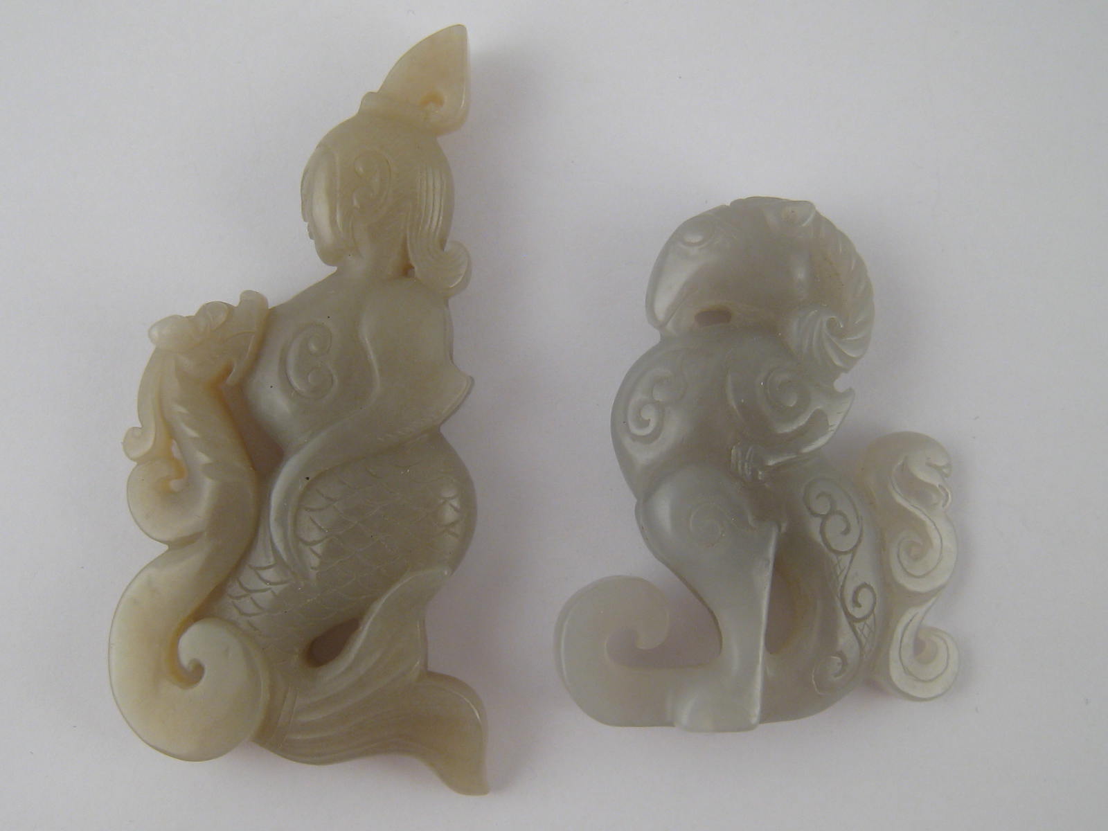 Two Chinese jade carvings, one a mermaid, the other a mythical beast, hts 9 and 8cm.