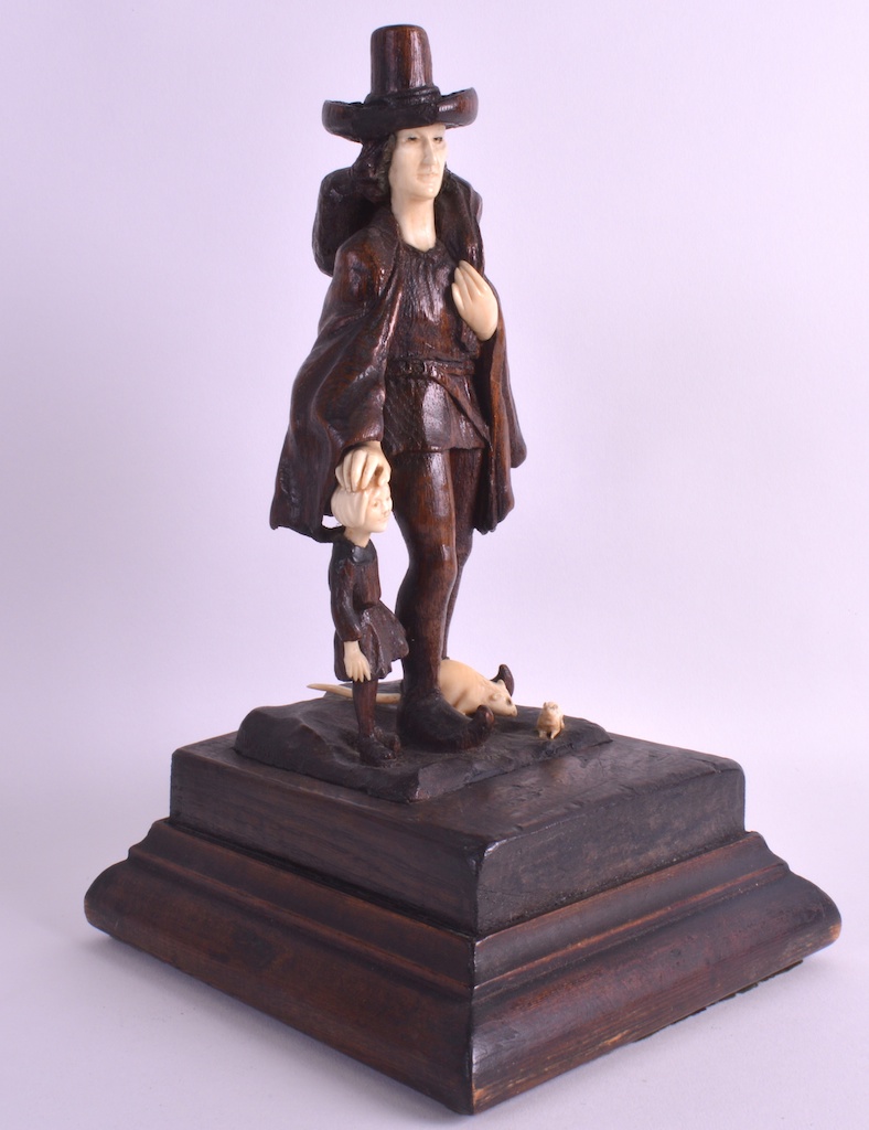 AN UNUSUAL 19TH CENTURY SOUTH GERMAN FOLK ART FIGURE OF A MALE modelled beside a small child, with