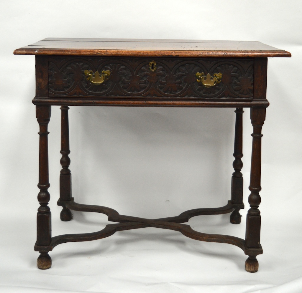 AN 18TH CENTURY OAK RECTANGULAR TOP LOWBOY with carved front drawer, upon tapering legs with uniting