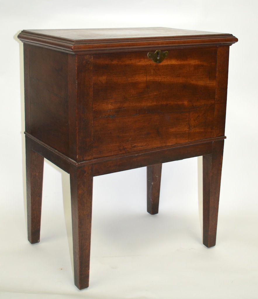 A GEORGE III RECTANGULAR CELLARETTE/WINE COOLER with rising top, supported on square tapering