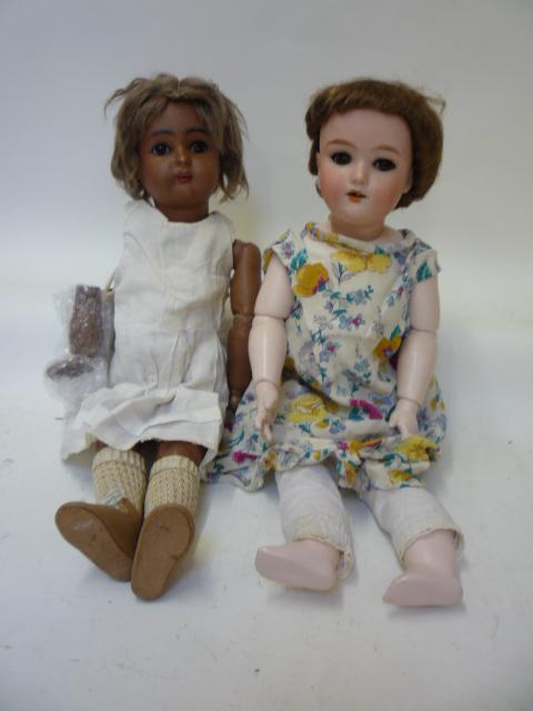 Dolls & Equipment. An Armand Marseille bisque head girl doll with brown glass sleeping eyes, open