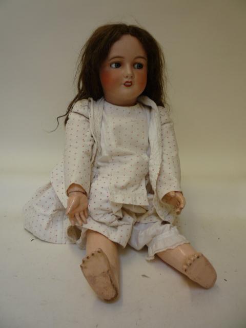 Dolls & Equipment. A Unis (France) bisque head girl character doll with blue glass flirty eyes, open