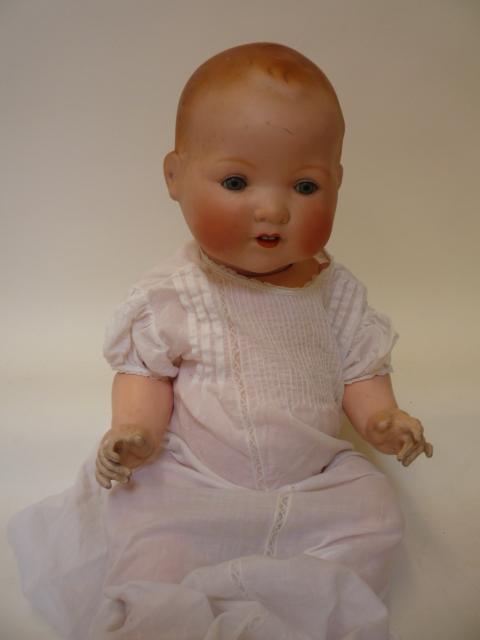 Dolls & Equipment. An Armand Marseille bisque head baby doll with blue glass sleeping eyes, open