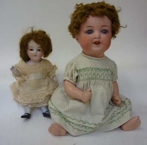 Dolls & Equipment. An Armand Marseille bisque head girl doll with blue glass sleeping eyes, open