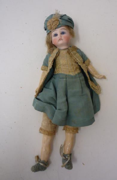 Dolls & Equipment. A Continental (probably French) bisque head doll with fixed blue glass eyes,