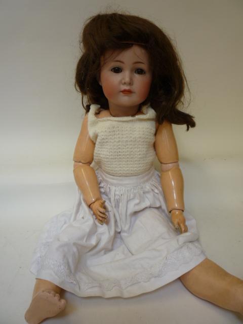 Dolls & Equipment. A Kammer & Reinhardt bisque head character girl doll with brown glass sleeping