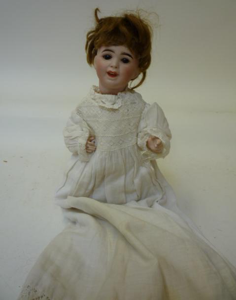 Dolls & Equipment. An S.F.B.J. bisque head laughing character doll with brown glass sleeping eyes,