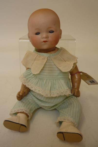 Dolls & Equipment. An Armand Marseille bisque head baby doll with blue glass sleeping eyes, closed